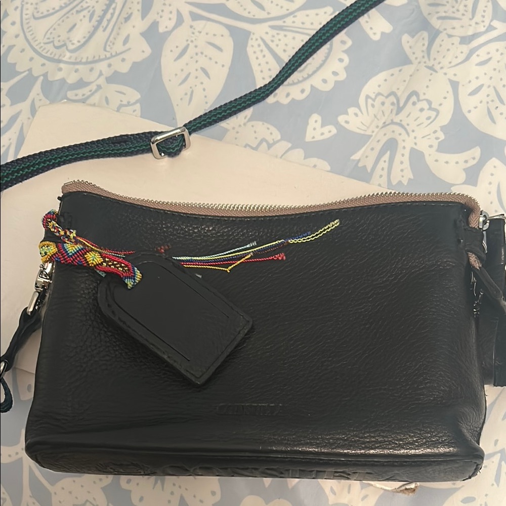 Black LeatherConsuela Downtown  Crossbody Bag with crocheted bracelet on tag.